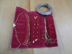 An African white metal bangle together with yellow metal chains,