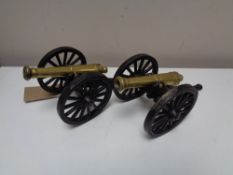 A pair of brass and metal cannons