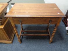 An Edwardian oak side table fitted with a drawer