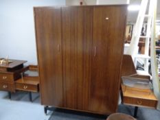 A mid century four piece bedroom suite comprising of triple door wardrobe, bedside cabinet,