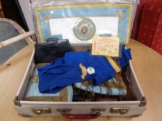A vintage suitcase containing Masonic apron,