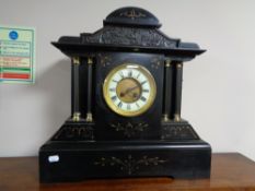 A nineteenth century black slate and gilt highlighted mantel clock