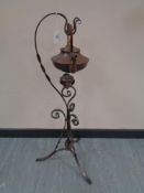 An Arts and Crafts copper spirit kettle with burner on stand, height 88 cm.