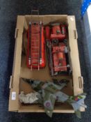 Two tin plate models of fire engines and another of a fighter jet.
