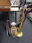 An embossed brass stick pot, ceramic vase, glass art vase,