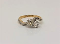 An antique 18ct gold old cut two stone diamond ring, approx. 1.
