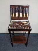 An oak barley twist cutlery table of plated cutlery