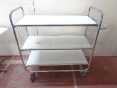 A tubular metal framed three tier trolley
