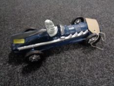A cast iron figure modelled as a blue Michelin racer