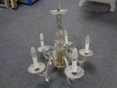 An antique glass five-branch chandelier with drops