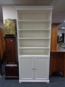 A set of white open bookshelves fitted cupboard beneath CONDITION REPORT: 96cm wide