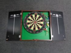 A Winmaw dart board cabinet containing a Nodor dart board