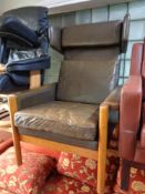 A mid 20th century teak framed leather upholstered wingback armchair