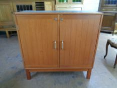 A mid 20th century teak double door office cabinet, 95cm wide by 40cm deep by 95cm high.