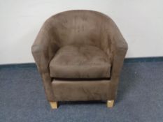 A tub chair in brown suede effect fabric