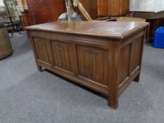 An oak linen fold blanket box, 105cm wide by 47cm deep by 51cm high.