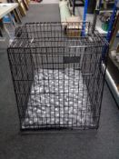 A folding metal dog cage, with liner and blanket,