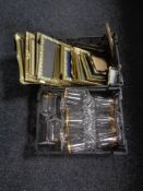 Two baskets of gilt rimmed wine glasses and assorted brass picture frames