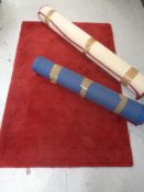Three contemporary red woolen rugs