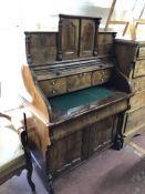 A 19th century mahogany shutter front bureau fitted drawer and cupboards beneath