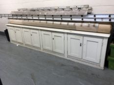 A white painted low sideboard fitted eight cupboard doors, length 381cm, width 50 cm,