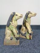 A pair of glazed pottery figures of horses,