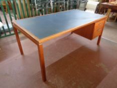 A 20th century teak single pedestal desk fitted two drawers