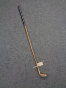 A hickory shaft brass headed golf club,