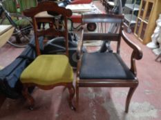An antique continental mahogany scroll armchair together with a further antique mahogany dining