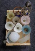A box of vintage glass light shades and two table lamps in the form of oil lamps