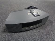 A Bose Wave music system with remote together with a boxed 7