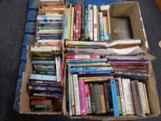 A pallet of four boxes of hardback and paperback books - novels,