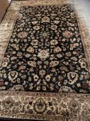 A machine made Persian design floral carpet on blue ground,