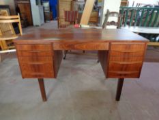 A mid 20th century teak twin pedestal desk, 121cm wide by 60cm deep by 72cm high.