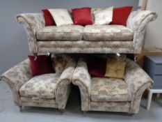 A three piece lounge suite in a floral fabric,