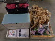 A crate containing Hessian shopping bags, floral wall paper, dry flowers,