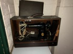 A cased Singer electric sewing machine
