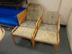 Two bamboo and wicker armchairs together with two similar footstools