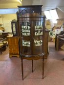 A double door mahogany corner display cabinet on stand bearing Fry's advertising