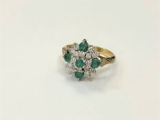 An 18ct gold emerald and diamond cluster, ring size N CONDITION REPORT: 5.
