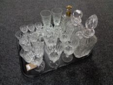 A tray of three lead crystal decanters and assorted drinking glasses