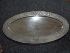 An Arts & Crafts pewter framed oval mirror 88 cm x 45 cm.