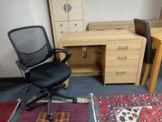 A contemporary oak three drawer computer desk and black mesh office chair