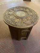 A circular Anglo-Indian carved hardwood folding table