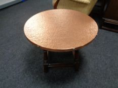 A circular copper topped coffee table