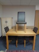 A contemporary kitchen table and three brown leather chairs