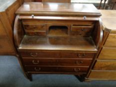 A mid 20th century beech cylinder writing bureau