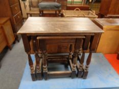 A nest of three oak tables