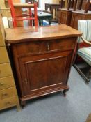 An antique mahogany cabinet fitted a drawer on raised legs
