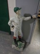 A painted composite garden figure of a jockey